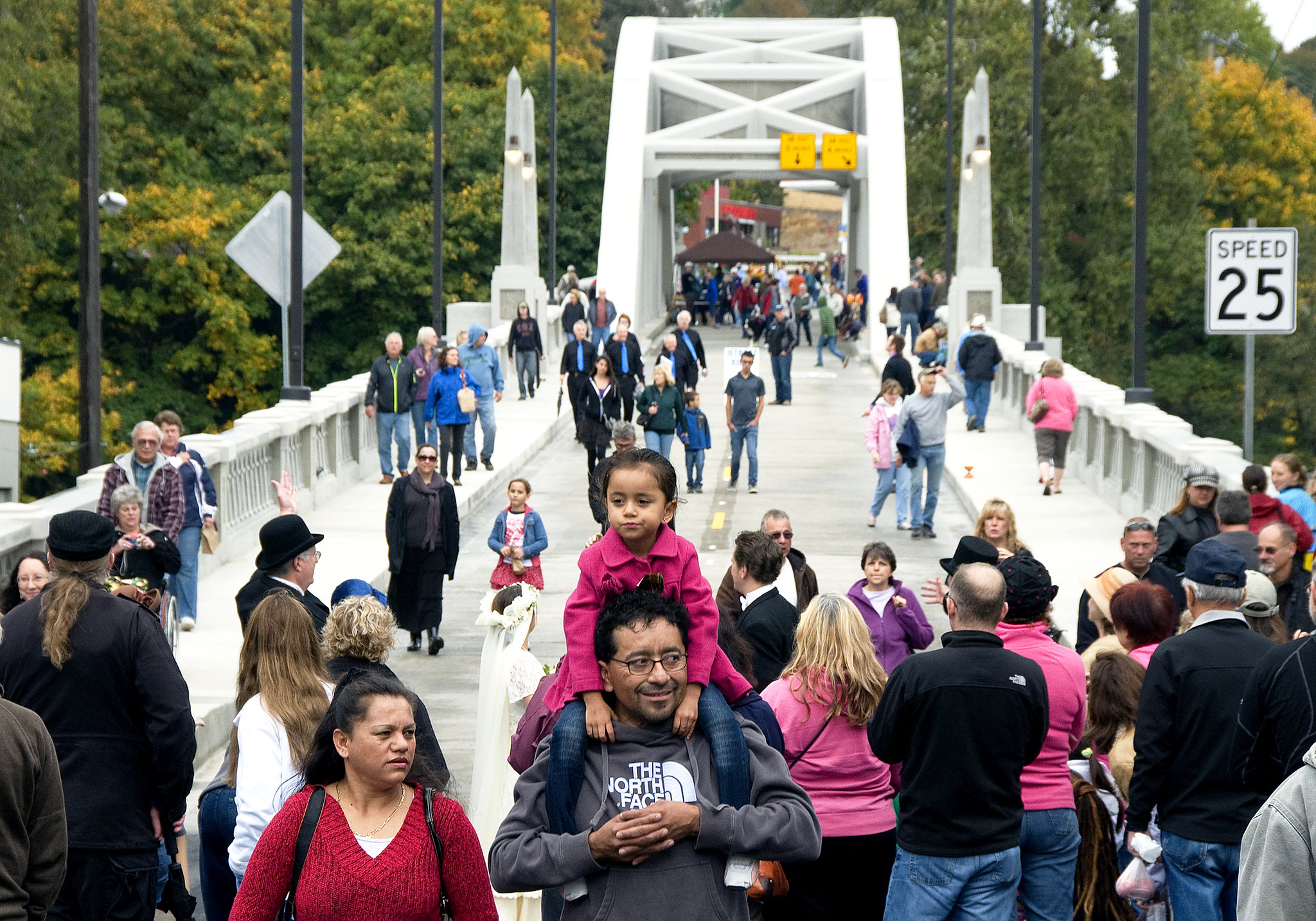 People enjoying walking across a new bridge